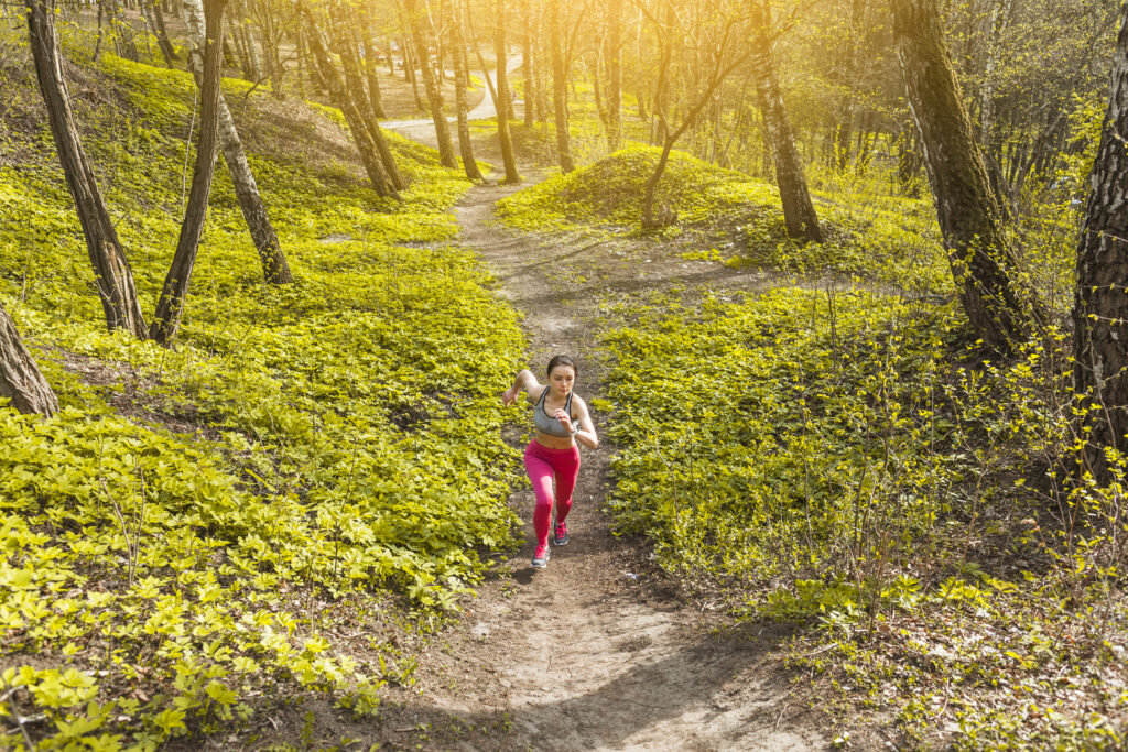 young-woman-running-through-trees